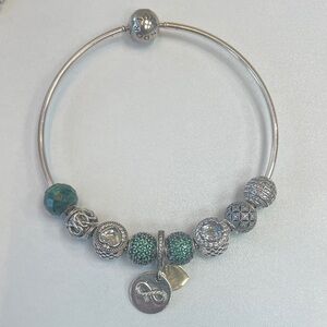 Pandora Essence bracelet with green and silver charms